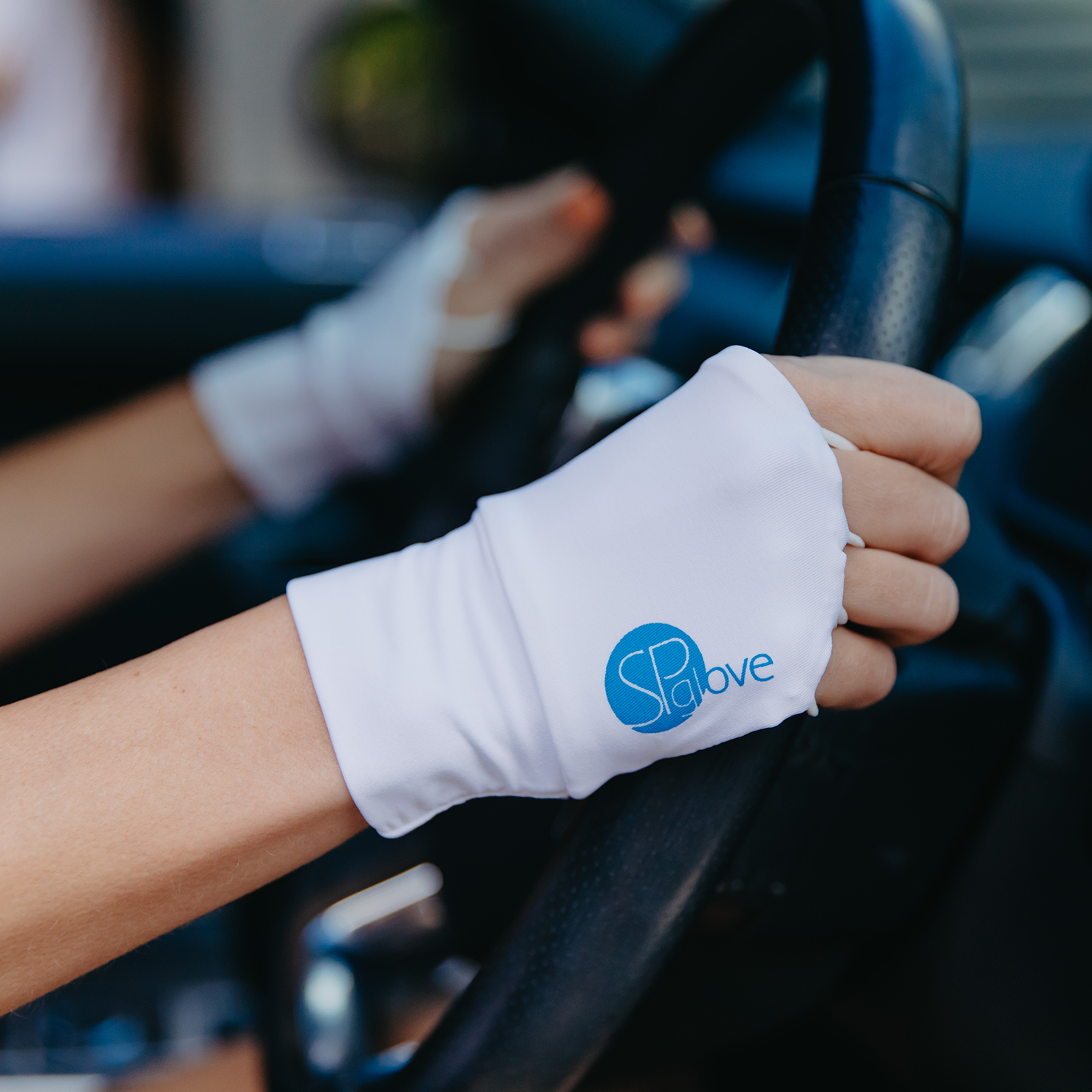 Image of a driver wearing SParms sun protective gloves.