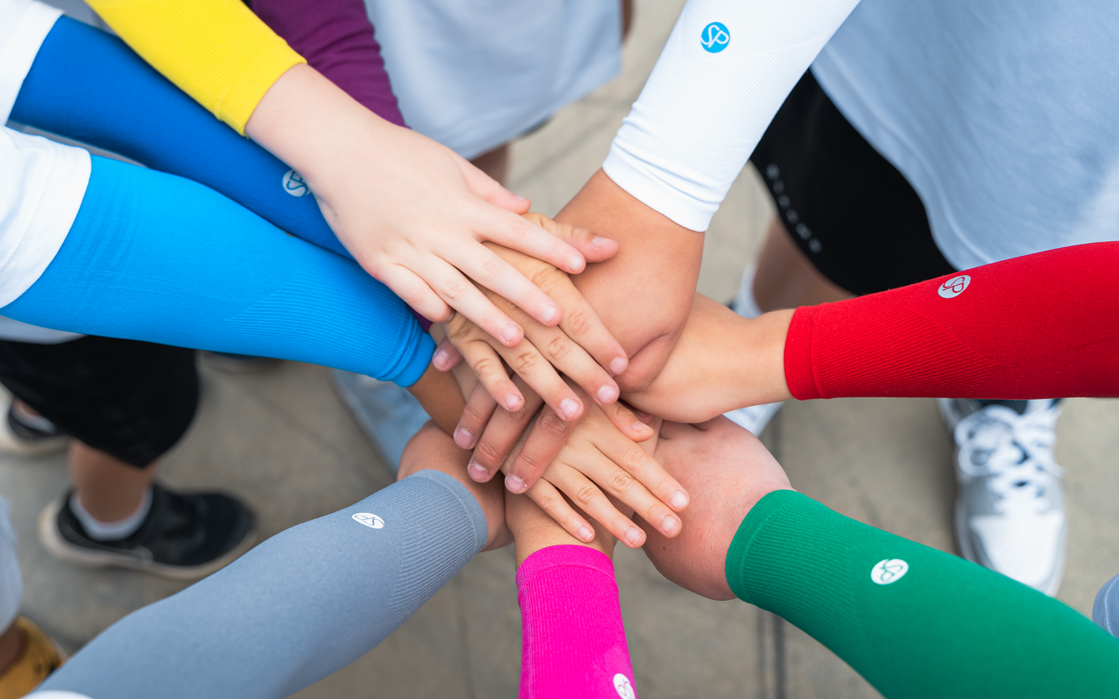 Image of kids wearing the every day sleeves in multiple colors.