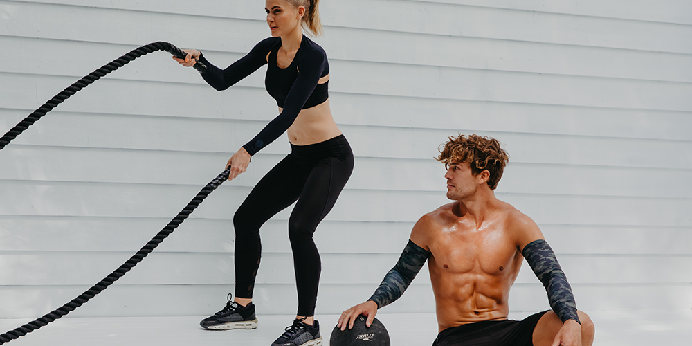Image of two people wearing SParms products while working out. 
